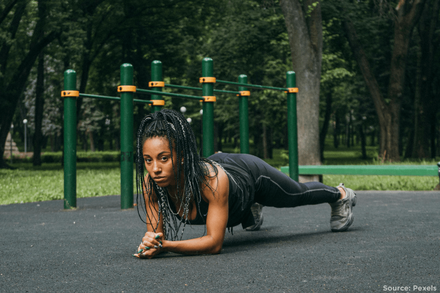 woman doing plank pose in a playground