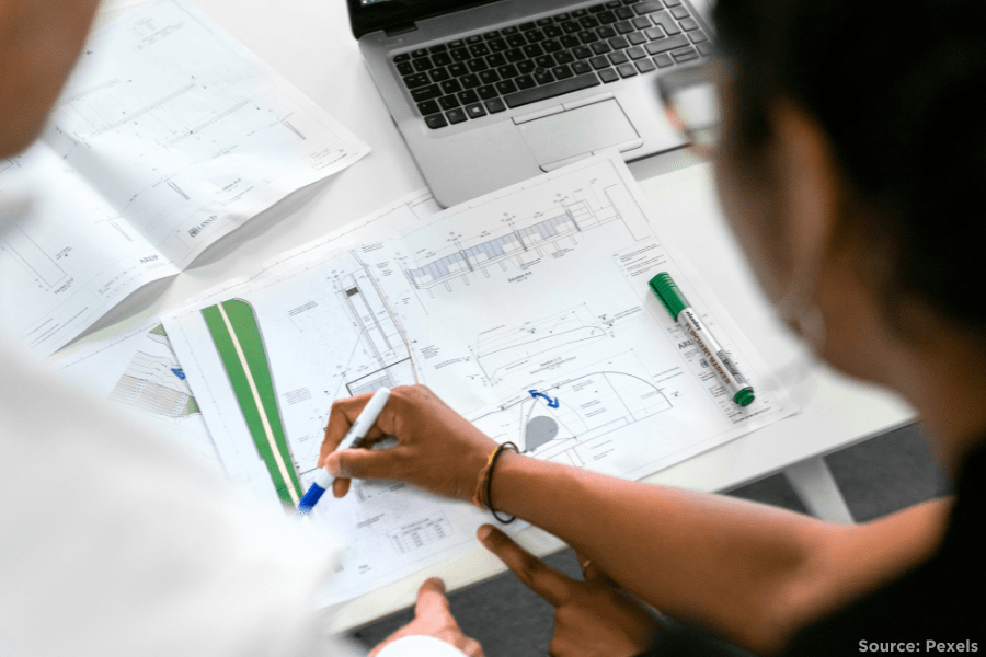 people drafting engineering plans