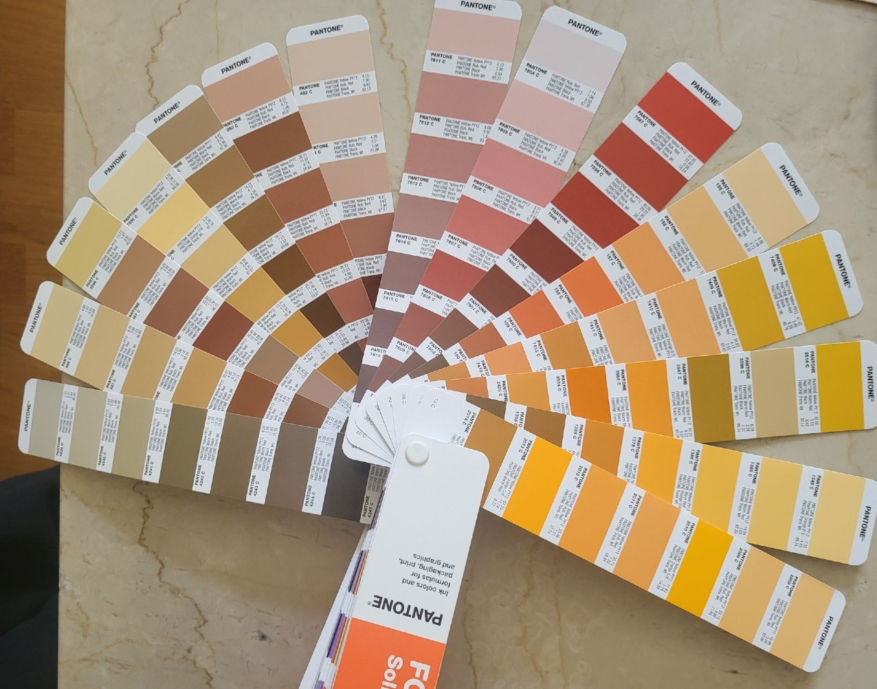 Photo of partially spread out Pantone chart.