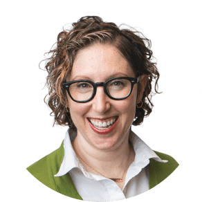 Headshot of a smiling woman wearing glasses