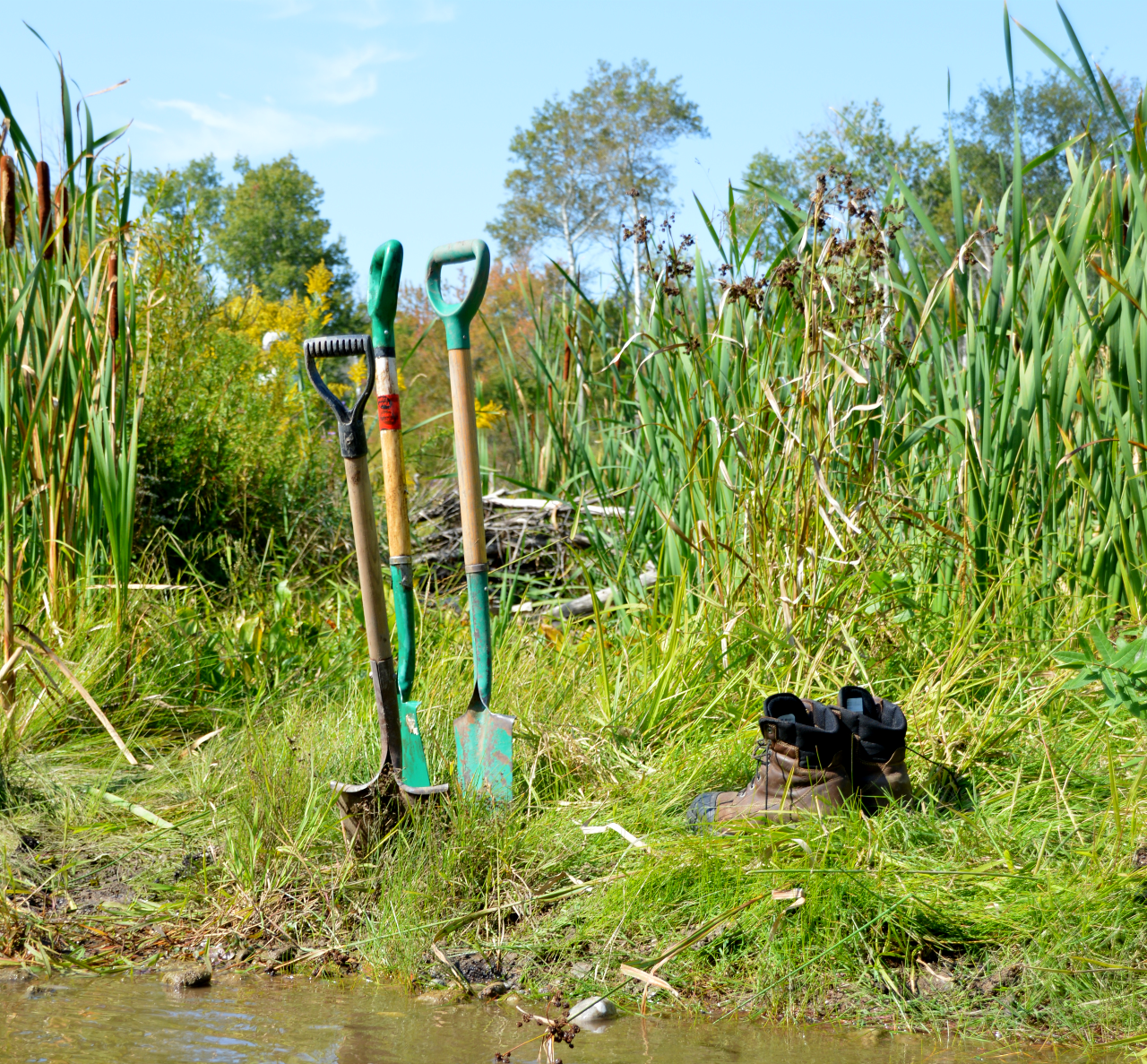 NVCA staff and a volunteer install revetments in a portion of the Nottawasaga river