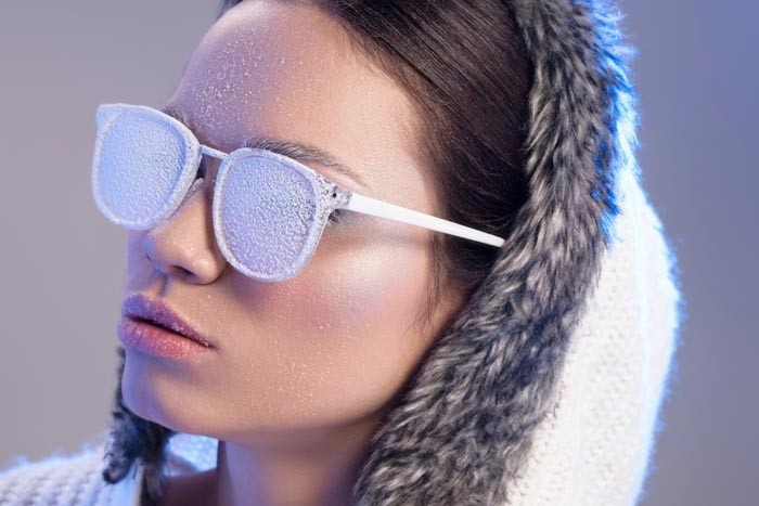 Woman with ice on glasses