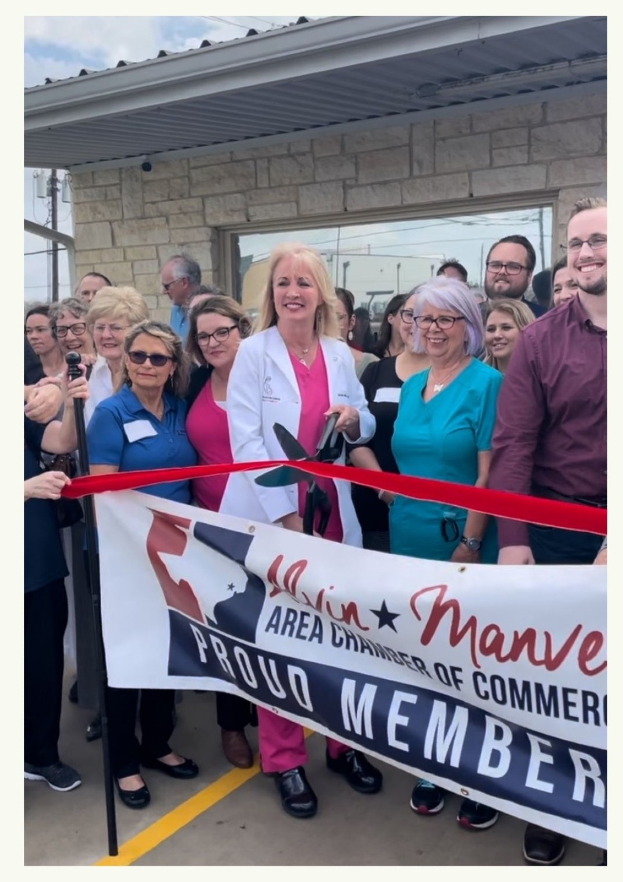 Renee pictures cutting the ribbon when HHPHC first opened.