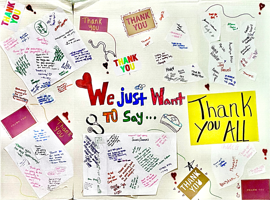 A large piece of cardboard covered in thank you letters from Manvel High School students