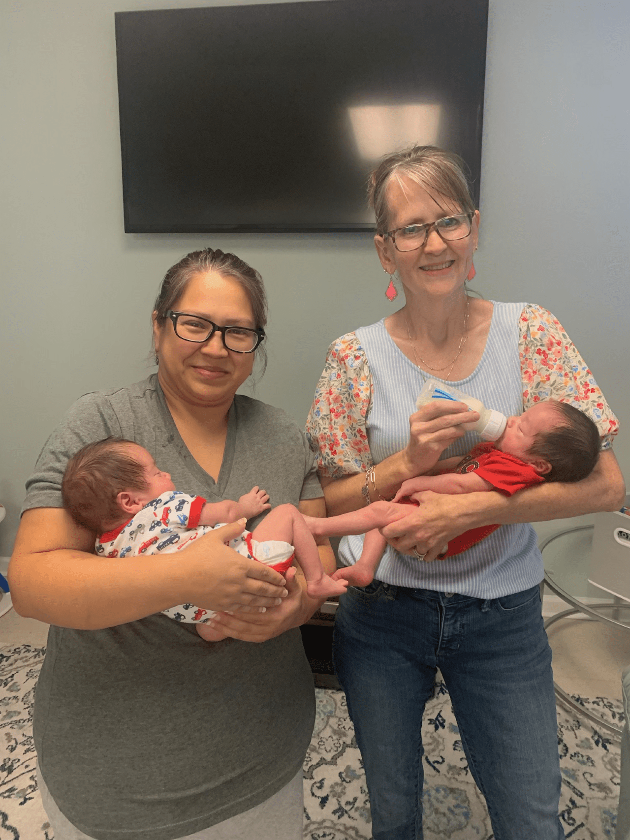 Mrs. Anne pictured holding a baby next to another woman holding a baby.