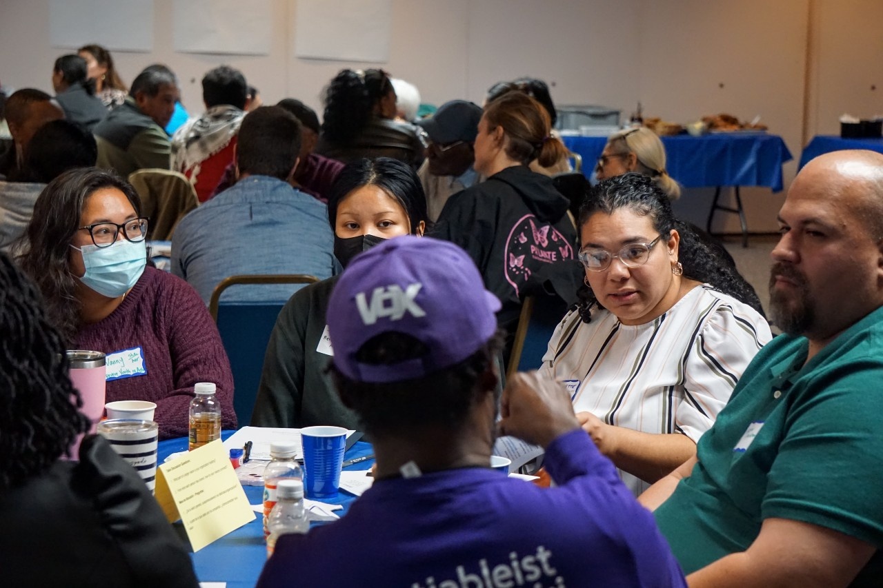 A photo of Black, Brown, Asian and white Deaf and hearing Lenny Zakim Fund Grantee recipients at the Grantee Gathering in conversation.
