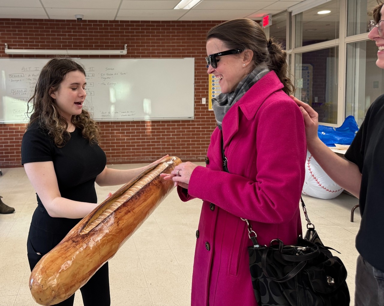 In the show, “The ducklings taunt Ugly with bread and patisserie," and Kerry Thompson holds said bread as Zoe delivers a backstage tactile tour.