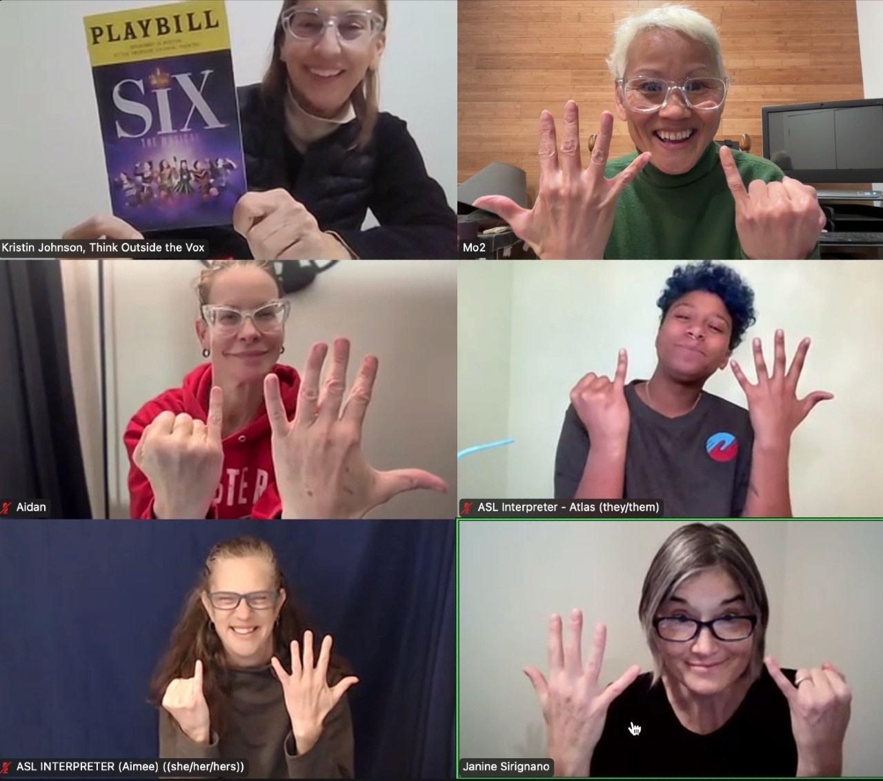 a group photo of the ASL team on Zoom for SIX The Musical. They are all holding up the show sign for SIX, which is both hands palms facing inward, one hand with all 5 fingers extended, and the other hand with only the pinky extended.