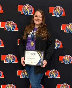 Ashley Brock receives an award for her work as a music instructor at Holdrege High School.