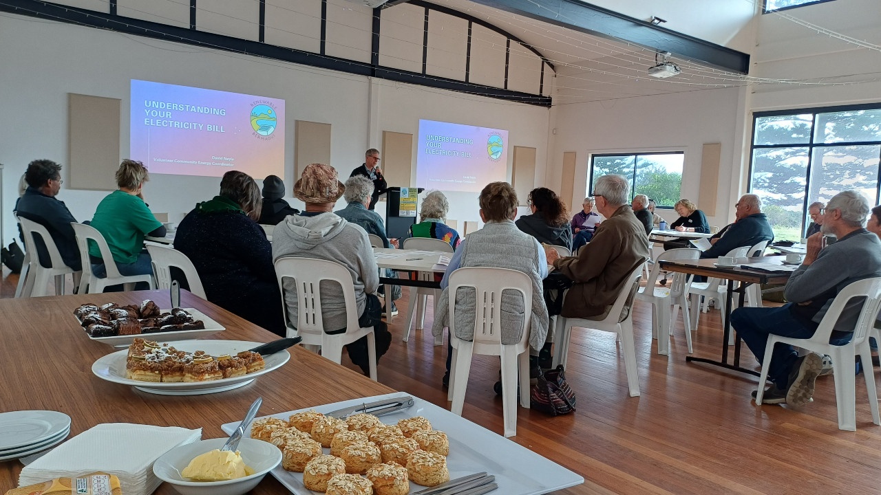 David Neyle starts off the "Know Your Energy Bill" workshop presentation. (With some delicious catering from Honorbread bakery in the foreground).