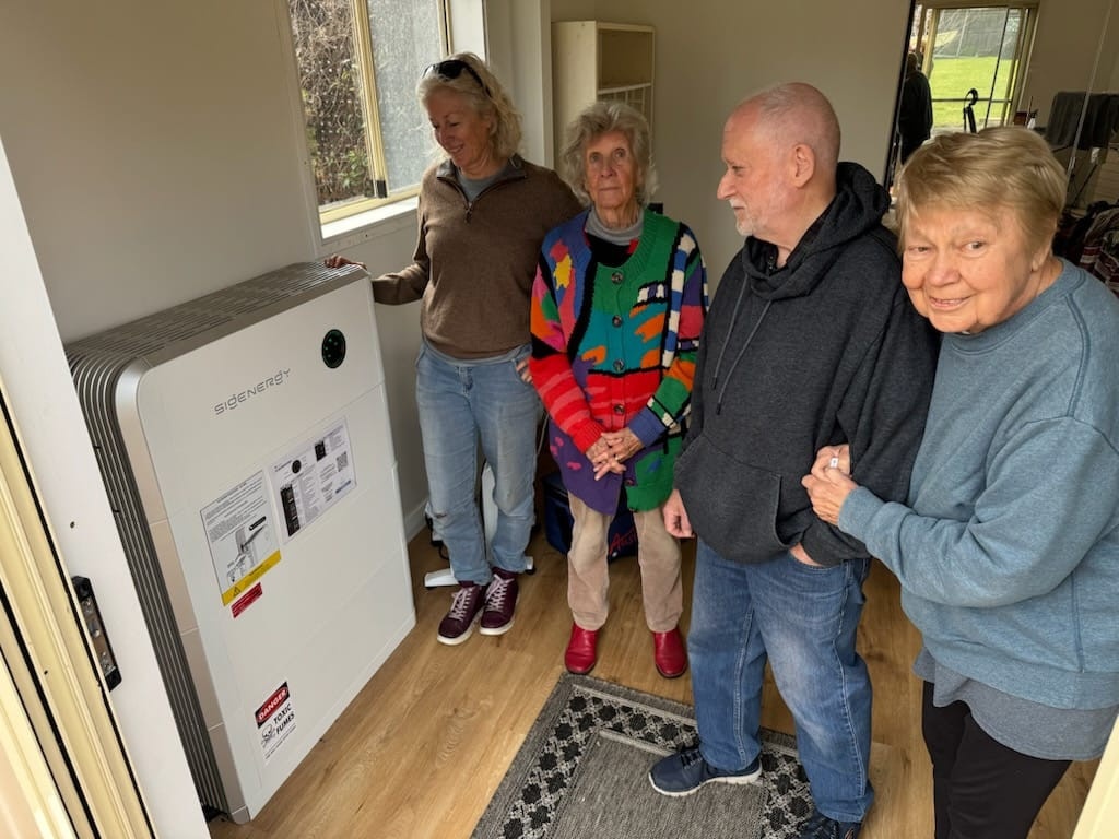 Deb showing the new Sigenergy battery system to visitors