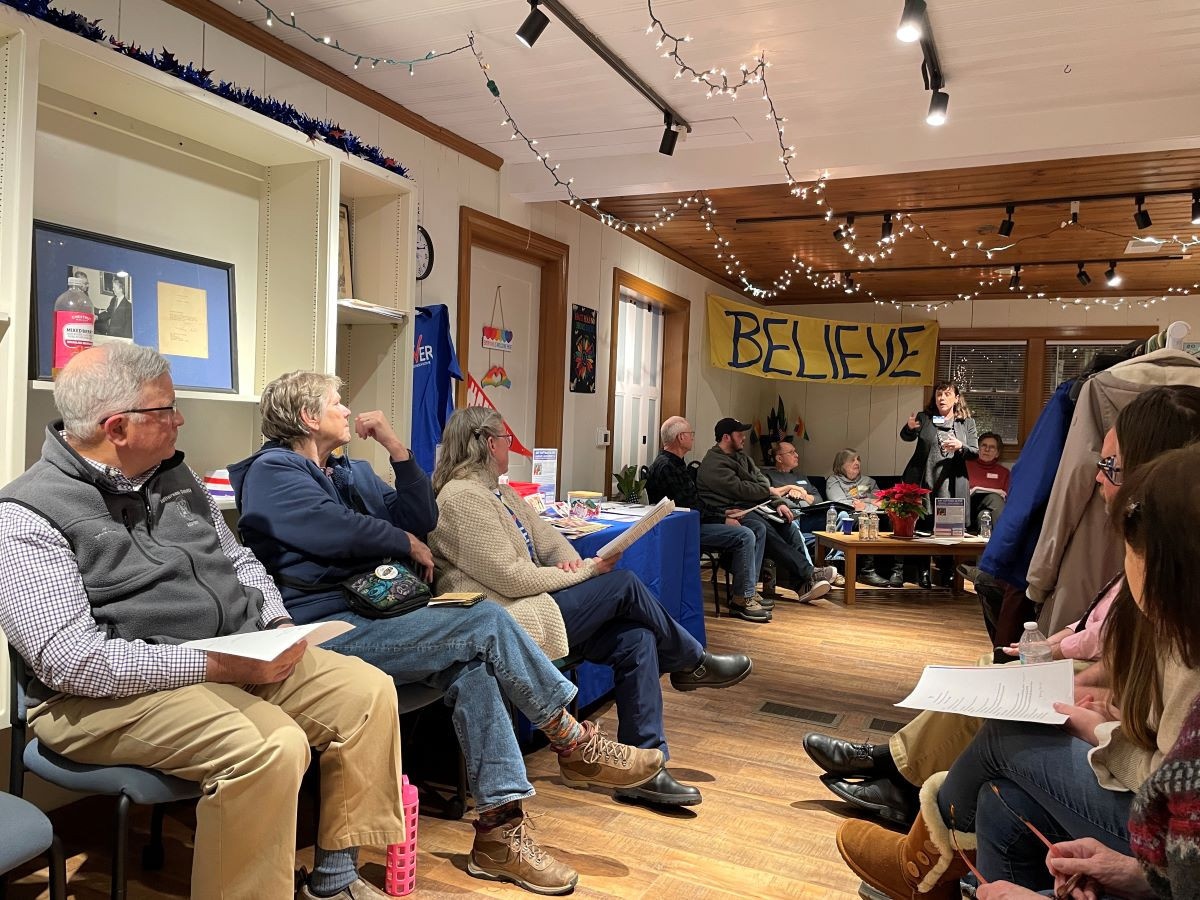 Meeting attendees listen to Amy Oliver address the group