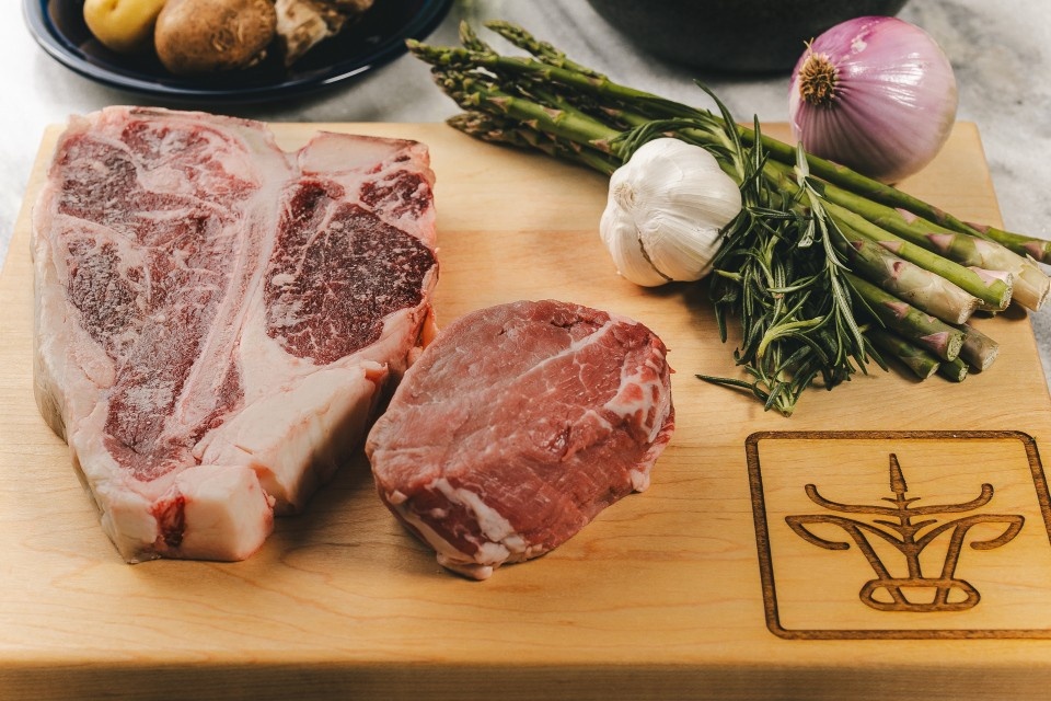 steaks with vegetables on a cutting board