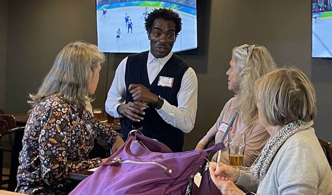 NCGA District 48 candidate Doyle Brown listening and sharing with Postcard Party attendees. Photo taken by Sheila Clendenning