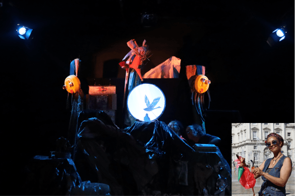 Still of a puppet show, showing the shadow of a bird being cast on a white circular background. Small insert featuring Carolene