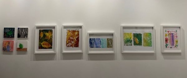 Second photograph of some of the artwork created during our art classes. These include techniques such as leaf printing and weaving.
