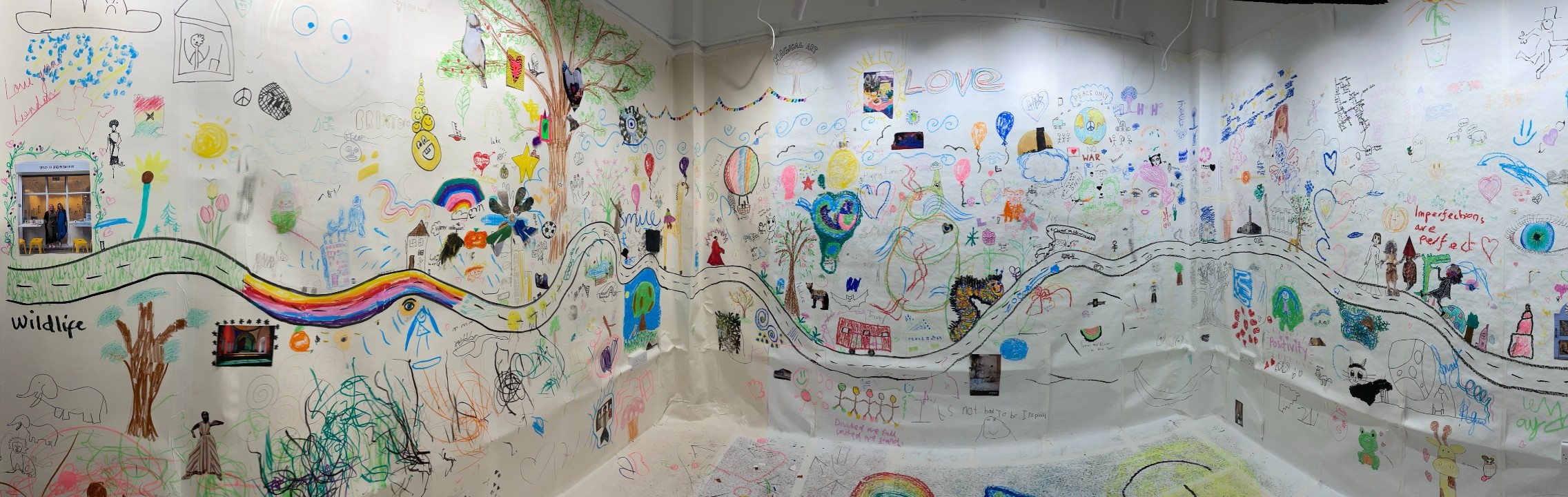 Our Village - Panoramic photography of the gallery at the end of our Big Draw day with the walla and floor covered in drawings and collages.