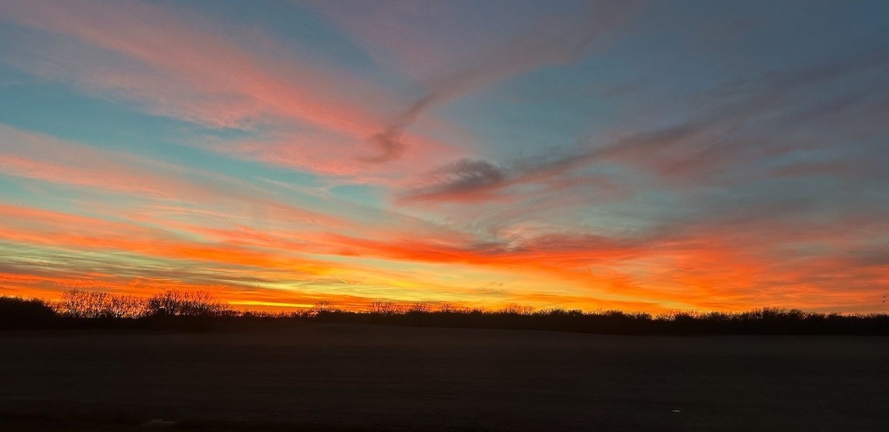 Mid-December sunset south of Lindsborg, Kansas with radiant orange and pink