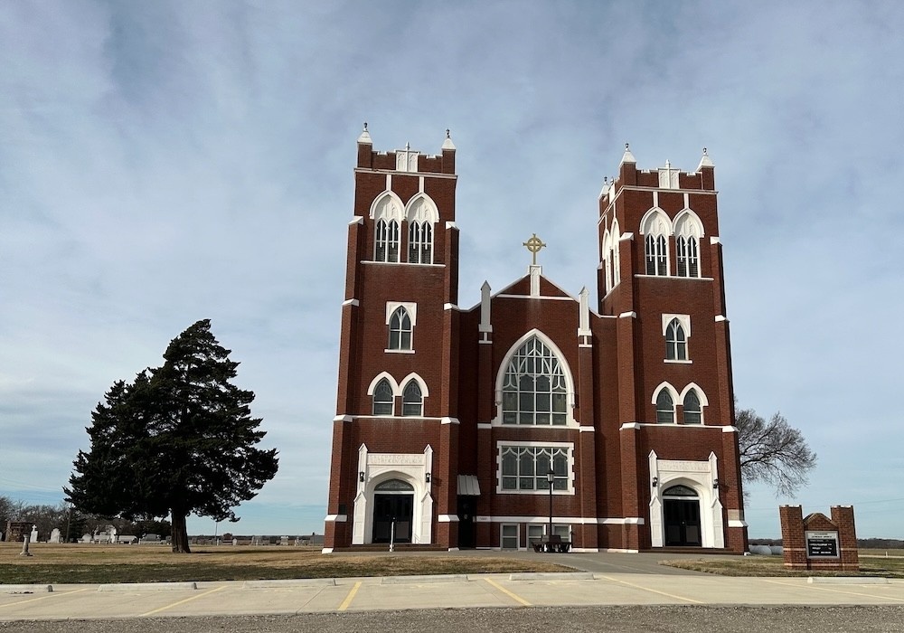 Two-pillar red brick church on the prairie