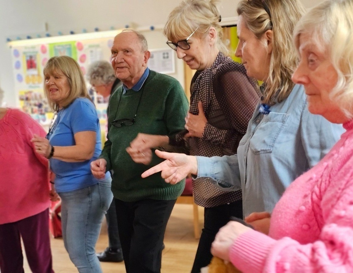 People dancing in Raleigh House, Staywell's flagship day centre in New Malden.