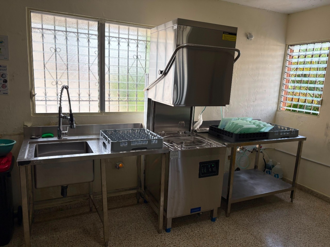 Industrial dishwashing set up in a restaurant kitchen inDominican Republic