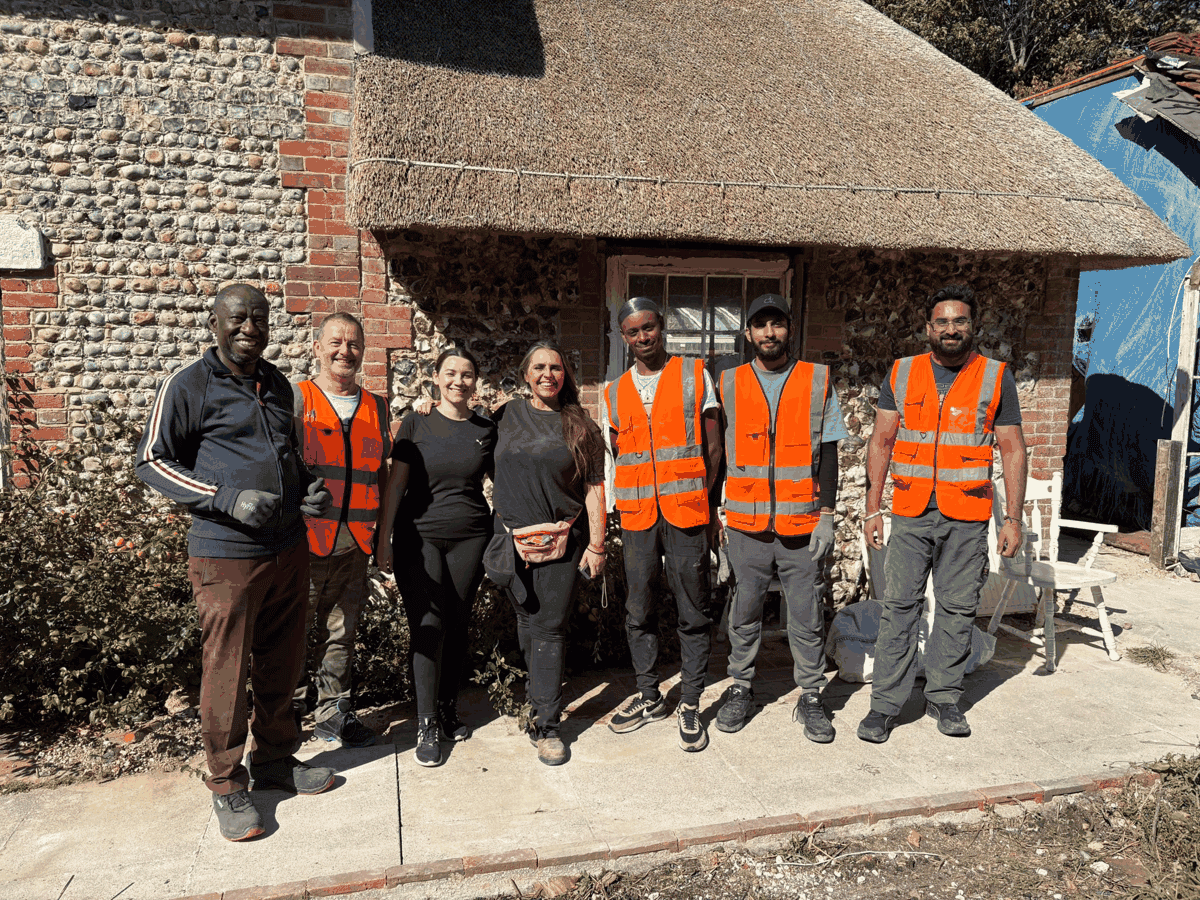 The Amazon volunteer team outside Blake Cottage after helping clear the cottage and garden in September 2026.