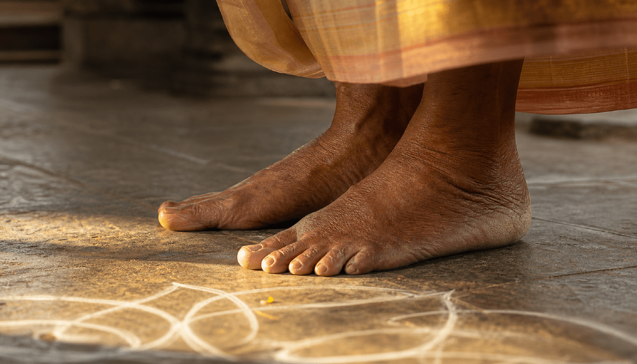 Elderly Indian parent's feet walking barefoot on temple floor