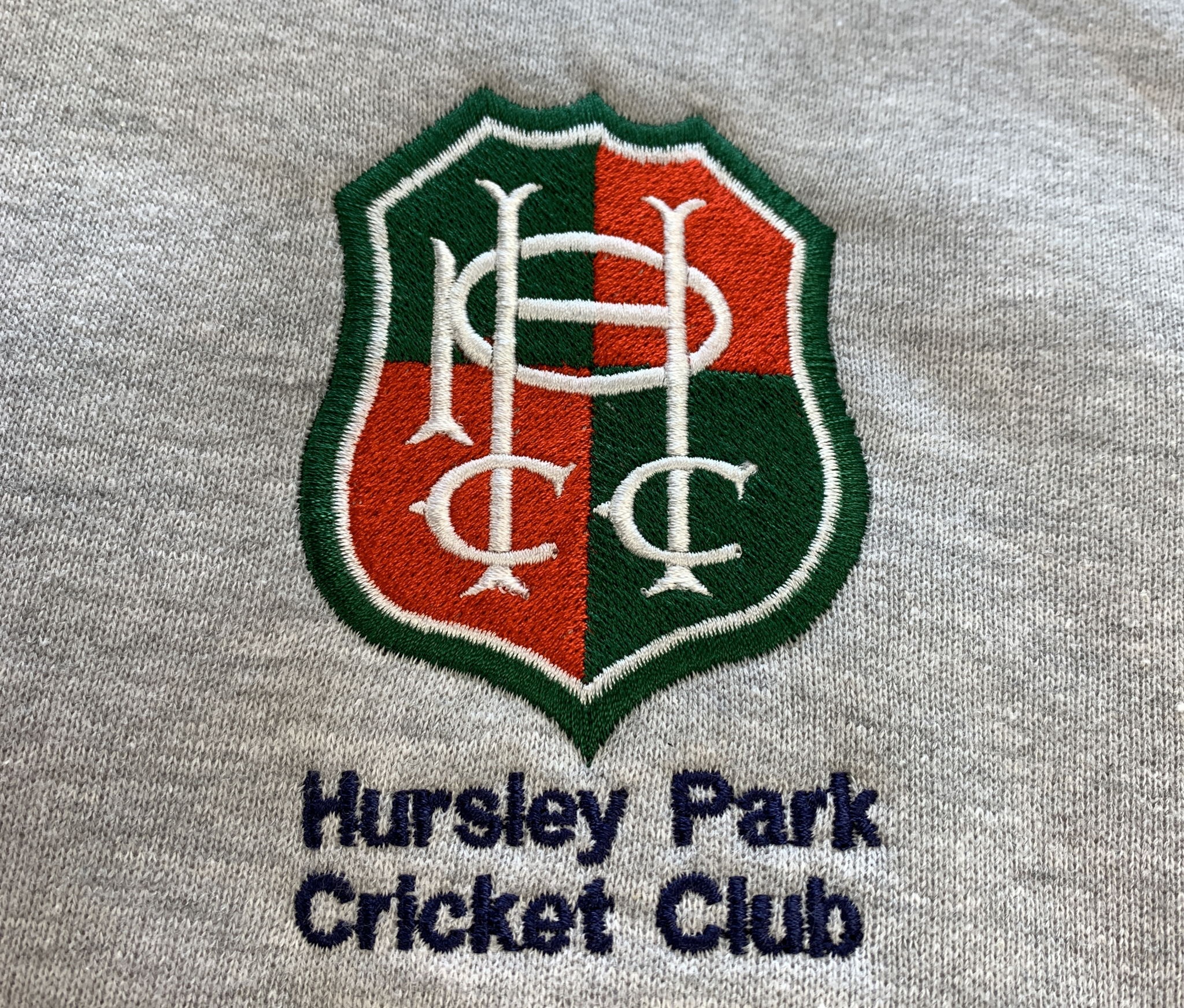 Hursley Park Cricket Club logo embroidered on a grey sweatshirt