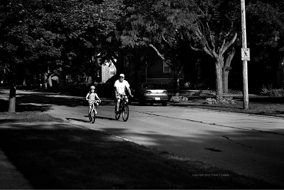 Photo: Daddy's Shadow - a Father and Daughter riding bikes down a neighborhood street - Copyright 2012 Frank J. Casella